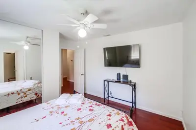 a bedroom with a bed and a ceiling fan at Steps to Restaurants Beach Bay Park Bars in San Diego