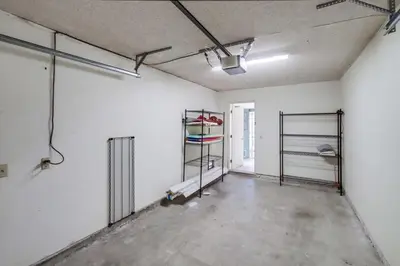 an empty room with white walls and metal shelves at Steps to Restaurants Beach Bay Park Bars in San Diego