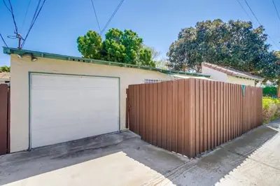 a garage door on a house with a fence at Steps to Restaurants Beach Bay Park Bars in San Diego