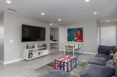 a living room with a couch and a flat screen tv at Cypress Cabana Chateau Luxury Vacation Villa in San Diego