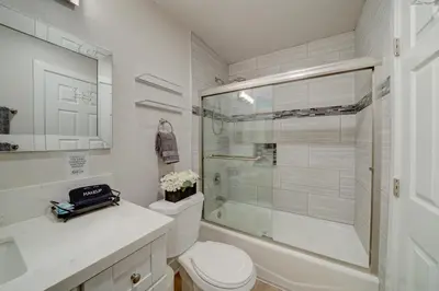 a bathroom with a toilet and a glass shower at 3 Mi to La Jolla Shores Relaxing Resort Retreat! in San Diego