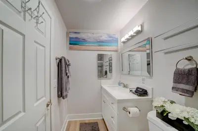 a white bathroom with a sink and a mirror at 3 Mi to La Jolla Shores Relaxing Resort Retreat! in San Diego