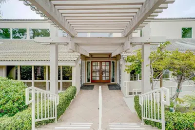 a white house with a pergola and a walkway at 3 Mi to La Jolla Shores Relaxing Resort Retreat! in San Diego