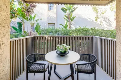 a table with two chairs and a vase on a patio at 3 Mi to La Jolla Shores Relaxing Resort Retreat! in San Diego