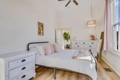 a bedroom with a white bed with a white dresser at The Stanton Residence - Chic and Cozy Classic near Downtown in San Diego