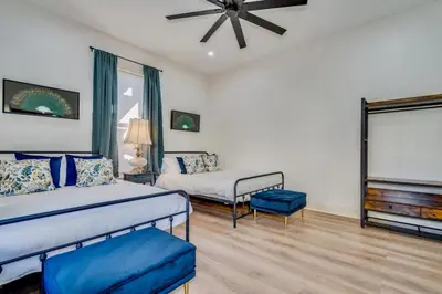 a bedroom with a bed and a couch and a tv at The Stanton Residence - Chic and Cozy Classic near Downtown in San Diego