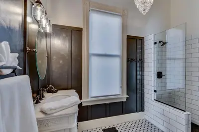a bathroom with a sink and a shower with a window at The Stanton Residence - Chic and Cozy Classic near Downtown in San Diego