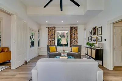 a living room with a white couch and chairs at The Stanton Residence - Chic and Cozy Classic near Downtown in San Diego