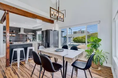 a dining room with a table and chairs and a kitchen at Sea house at Sea shore - 4 bedroom 3 bath - 14 ppl in San Diego
