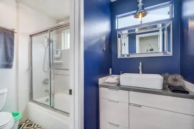 a blue bathroom with a sink and a shower at Sea house at Sea shore - 4 bedroom 3 bath - 14 ppl in San Diego