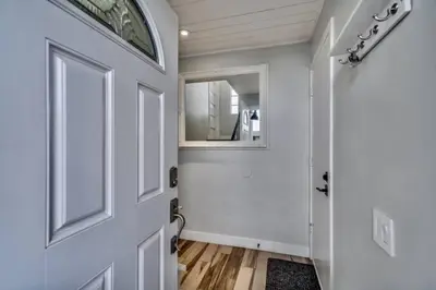 a hallway with a white door and a mirror at Sea house at Sea shore - 4 bedroom 3 bath - 14 ppl in San Diego