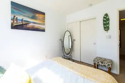 a bedroom with a bed and a mirror at Cali Condo+BBQ+MemoryFoamBeds+12min to Beach in San Juan Capistrano