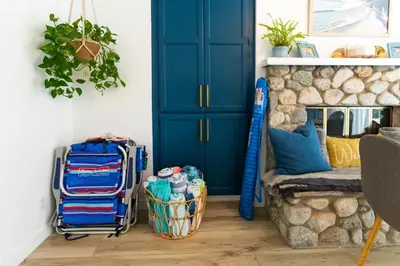 a room with a blue door and luggage on the floor at Private House 3 min to beach large backyard Spa Sauna BBQ ! in San Juan Capistrano