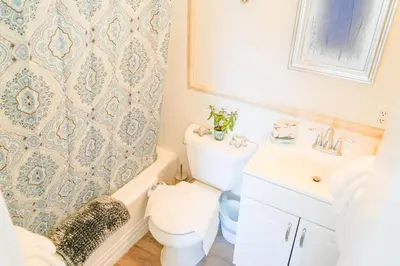a bathroom with a toilet and a sink at STUNNINGLY PERFECT Beach ALL NEW REMODEL Galore in Laguna Beach