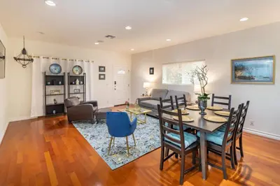 a dining room and living room with a table and chairs at Stunning huge one level 1350 ft. cottage in Mission Viejo