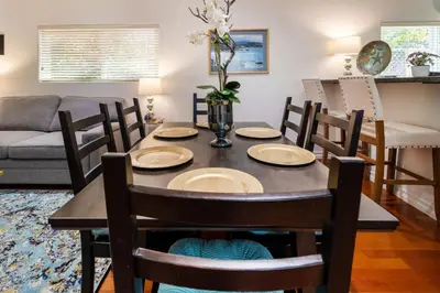 a dining table and chairs in a living room at Stunning huge one level 1350 ft. cottage in Mission Viejo