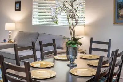 a dining room table with four chairs and a couch at Stunning huge one level 1350 ft. cottage in Mission Viejo