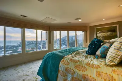 a bedroom with a bed with a view of the ocean at UNEQUALLED LUXURY VILLA BEACH 7000ft 180 VIEW in Laguna Beach