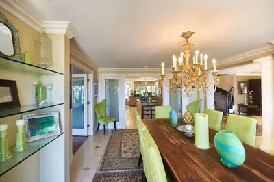 a dining room with a table and a chandelier at UNEQUALLED LUXURY VILLA BEACH 7000ft 180 VIEW in Laguna Beach