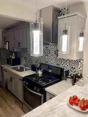 a kitchen with a stove and a sink and a counter at 100 PERCENT NEW STUNNING HUGE HOME, GARDEN BEACH, RESERVED Parking in Laguna Beach