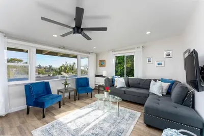 a living room with a blue couch and blue chairs at 100 PERCENT NEW STUNNING HUGE HOME, GARDEN BEACH, RESERVED Parking in Laguna Beach