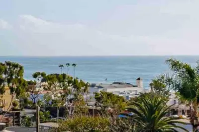 a view of a city with the ocean in the background at 100 PERCENT NEW STUNNING HUGE HOME, GARDEN BEACH, RESERVED Parking in Laguna Beach