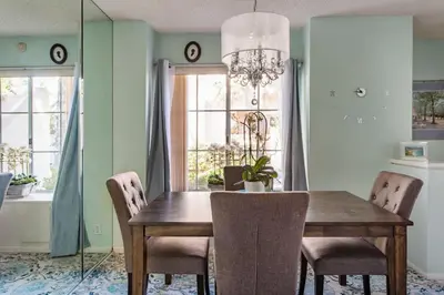 a dining room with a wooden table and chairs at Glamorous Regal Design Home with Private Patio and Garage in Laguna Hills