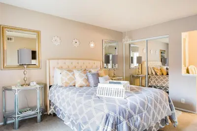 a bedroom with a large bed and a mirror at Glamorous Regal Design Home with Private Patio and Garage in Laguna Hills