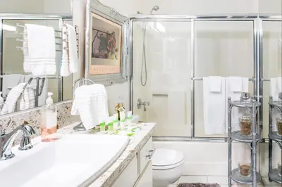 a bathroom with a shower and a sink and a toilet at Glamorous Regal Design Home with Private Patio and Garage in Laguna Hills