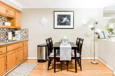 a dining room with a table and chairs in a kitchen at Unparalleled Villa Apartment in an Enchanting Village in Laguna Beach
