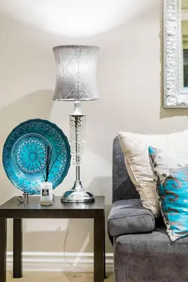 a lamp on a table next to a couch at Unparalleled Villa Apartment in an Enchanting Village in Laguna Beach
