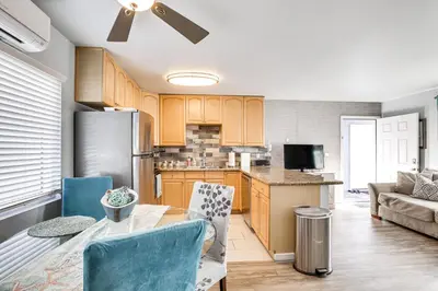a kitchen and living room with a table and chairs at Updated Mission Beach Condo Walk to Belmont Park! in San Diego