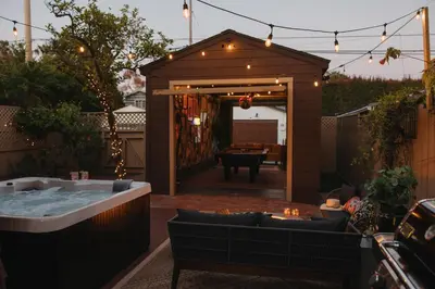 a backyard with a jacuzzi tub and a patio at Balboa 6BR Mansion with Hot Tub and Game Room in San Diego