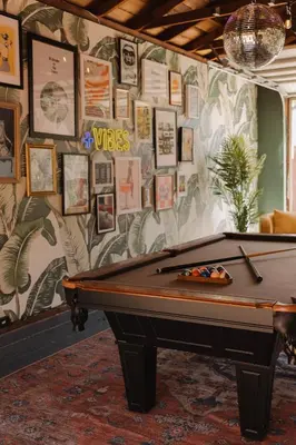a pool table in front of a wall with pictures at Balboa 6BR Mansion with Hot Tub and Game Room in San Diego