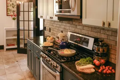 a kitchen with a stove with vegetables on the counter at Balboa 6BR Mansion with Hot Tub and Game Room in San Diego