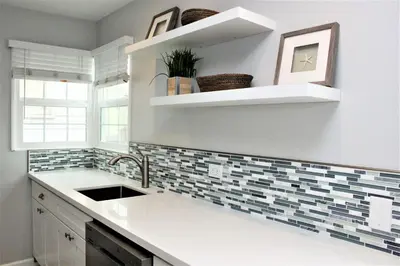 a kitchen with a sink and a counter top at Balboa Paradise - Renovated Coastal Haven in Newport Beach