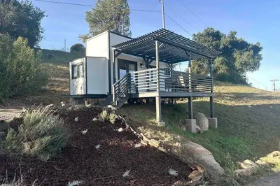 a small house sitting on top of a hill at Tiny House - mountain views close to everything in Valley Center