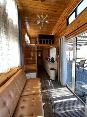 a living room with a couch in a house at Tiny House - mountain views close to everything in Valley Center