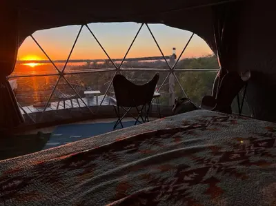 a room with a bed and a view of the sunset at Sunset Dome - Outdoor Shower/Composting Toilet in Valley Center