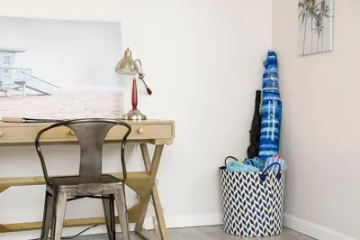 a desk with a lamp and a chair next to a wall at Perla D'Italia -1BR- FREE Driveway Parking -1 Car in San Diego