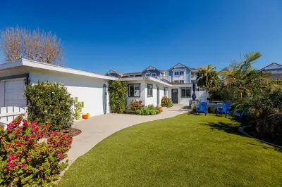 a large house with a lawn in front of it at Charming Beach Bungalows - 4BR, Sleeps 10, Pets OK in Carlsbad