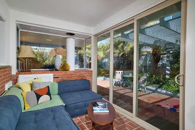 a living room with a blue couch and a table at Family Beach house in Carlsbad