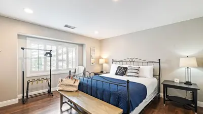 a bedroom with a bed and a table and a window at Breathtaking Meadows by AvantStay Temecula Group Retreat Pool Pickleball Firepit Hot Tub in Temecula