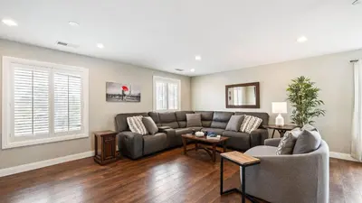 a living room with a couch and a table at Breathtaking Meadows by AvantStay Temecula Group Retreat Pool Pickleball Firepit Hot Tub in Temecula