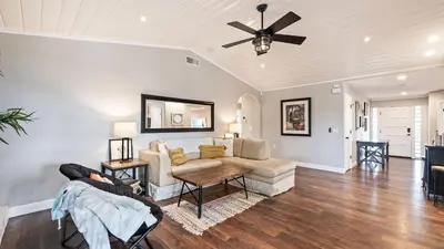 a living room with a couch and a ceiling fan at Breathtaking Meadows by AvantStay Temecula Group Retreat Pool Pickleball Firepit Hot Tub in Temecula