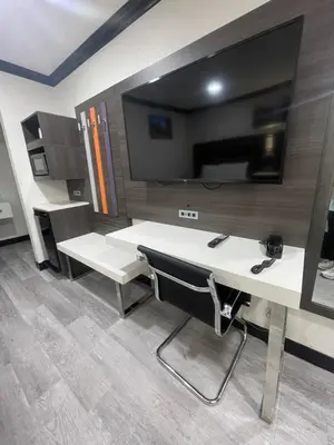 an office with a desk and a tv on a wall at Escondido Lodge in Escondido
