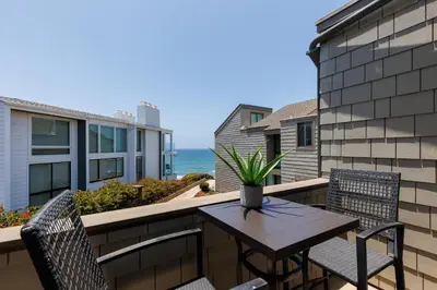 a table and chairs on a balcony with the ocean at SB-6758 - Italian Coastal Getaway in Solana Beach