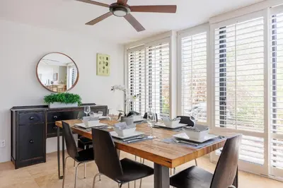 a dining room with a table and a ceiling fan at SB-6758 - Italian Coastal Getaway in Solana Beach
