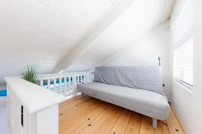 a white room with a bench in a attic at SB-6758 - Italian Coastal Getaway in Solana Beach
