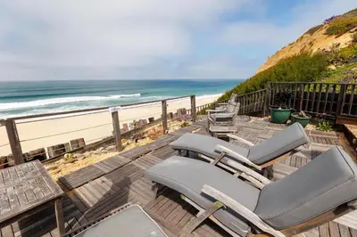 a deck with chaise lounge chairs and the beach at SB-6758 - Italian Coastal Getaway in Solana Beach